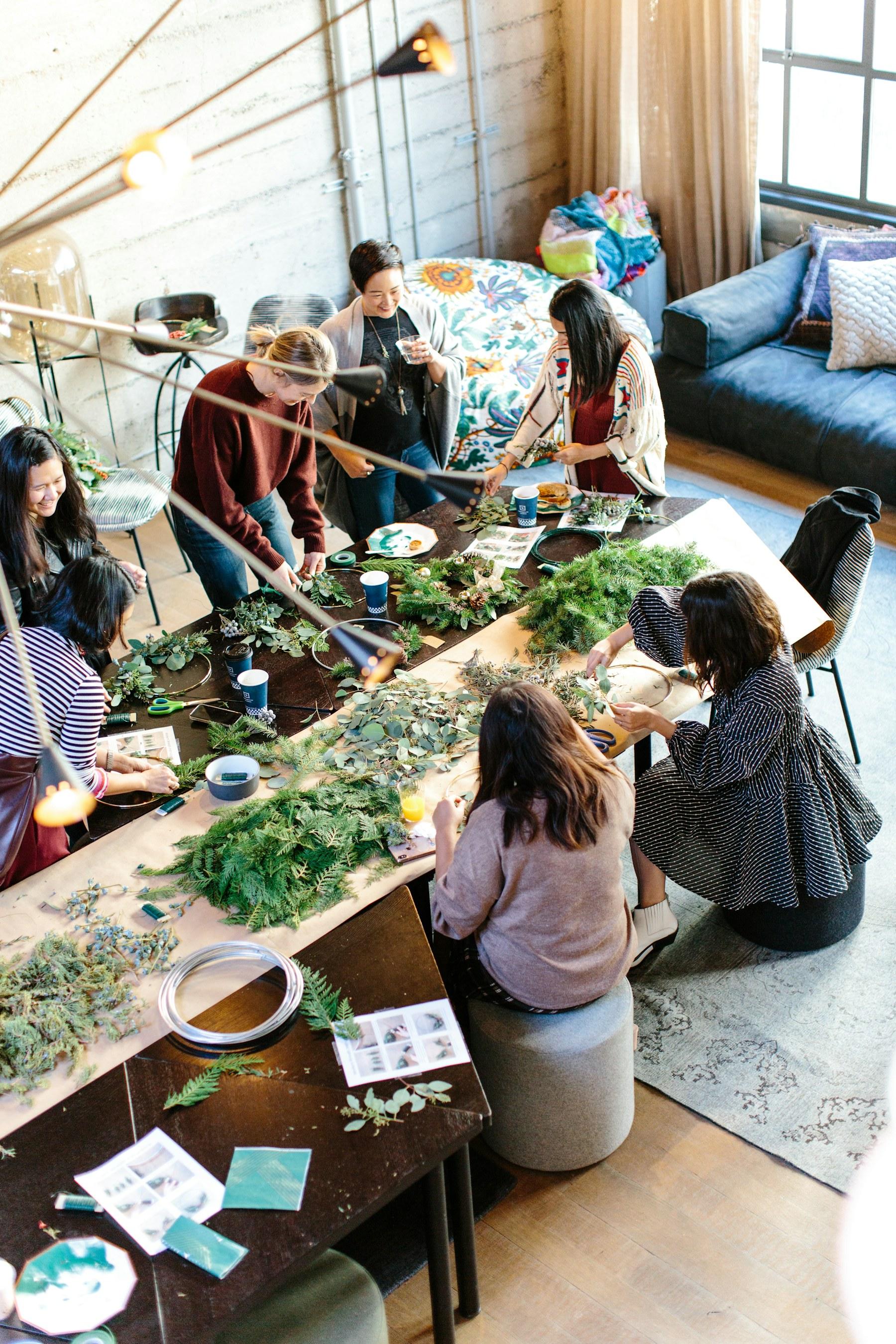 Women gathered around a table during a hands-on workshop